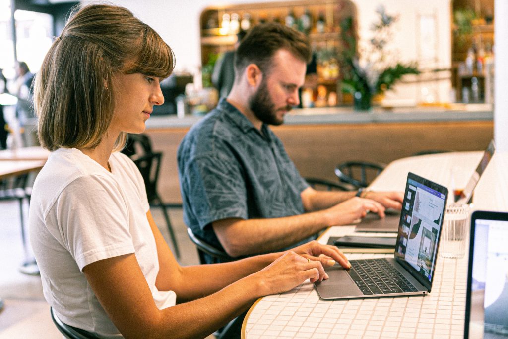 Two people using laptops.