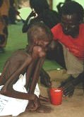 photo of an emaciated, starving young man in an African refugee camp
