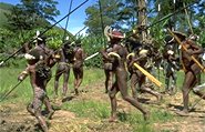photo of charging Papuan men with spears