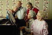 photo of an elderly American group singing together at a piano