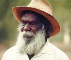 photo of an elederly Australian Aborigine man wearing a European style shirt and hat