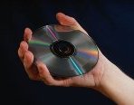 Photo of a hand holding a CD disk
