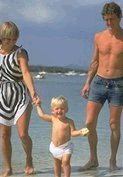 photo of a North American husband, wife, and their young child at a beach