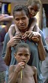 Photo of a mother and her two children in Papua New Guinea
