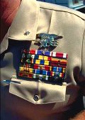 photo of a U.S. Navy Seal's shirt showing his insignia of rank, branch of the Navy, and his military achievement ribbons