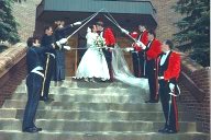 photo of a military wedding with the newly married couple walkiing under an arch of swords