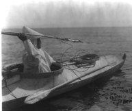 Early 20th century photo of an Eskimo sea mammal hunter in a kayak