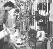 photo of a man working with a radiocarbon dating sample that has been converted to  acetylene gas for analysis with a mass spectrometer