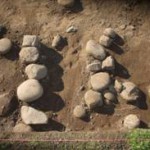 Two stone alignments in an excavation