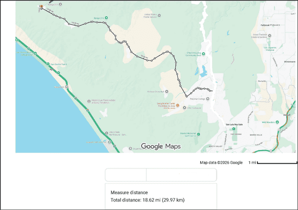 Map 9: Route to SOI West Combat Instructor School
Google Maps view showing a route to SOI West Combat Instructor School across Camp Pendleton. The route is marked by a dark line with multiple turns, beginning near the San Luis Rey Gate area on the right side of the map and traveling west and north through the base. The path follows major roads including Vandergrift Boulevard, Rattlesnake Canyon Road, and Basilone Road, winding through hilly and undeveloped terrain.

The route continues toward the northwest portion of the base, ending near the coastline at the SOI West training area. The Pacific coastline and Interstate 5 are visible along the left side of the map, while inland areas show base facilities, open land, and limited labeled landmarks. A scale at the bottom indicates a total distance of approximately 18.6 miles (29.97 kilometers).