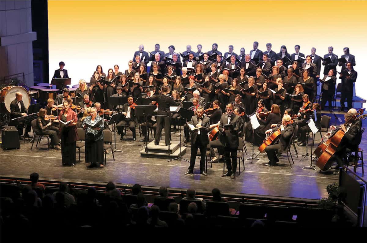 Palomar College choir and orchestra perform together during a live concert.
