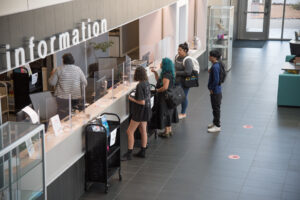 students waiting for assistance in an information desk