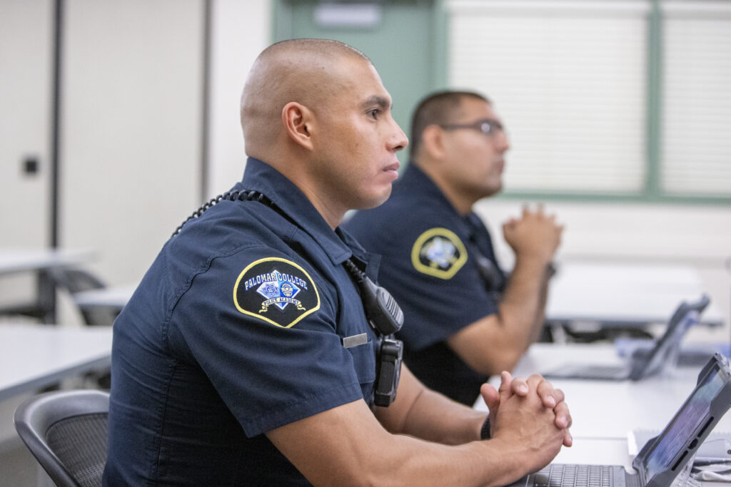 Police Academy officers sit at tables in a classroom.