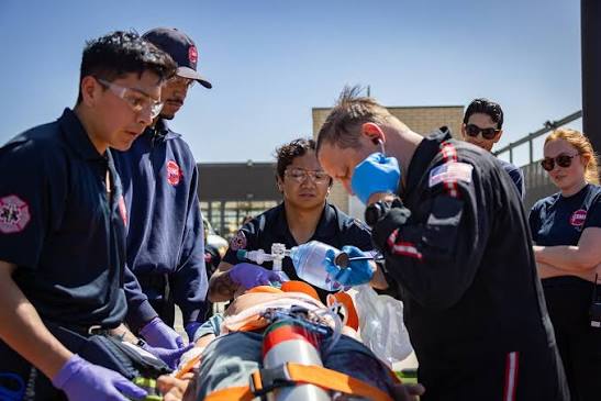 EME students give oxygen to a patient on a gurney