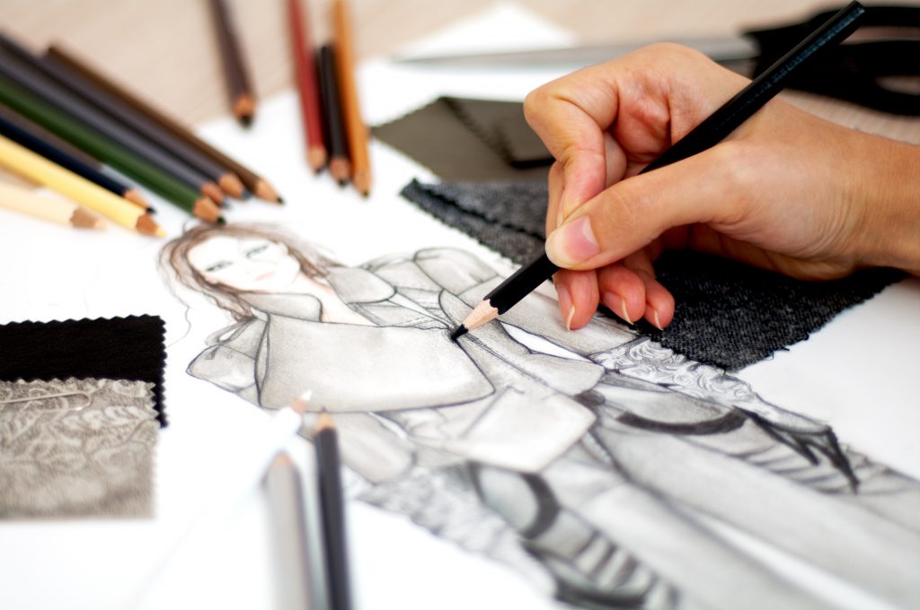 fashion illustration being drawn with colored pencils