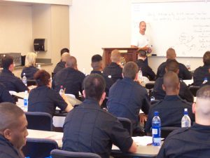 Student in police uniforms are in class.