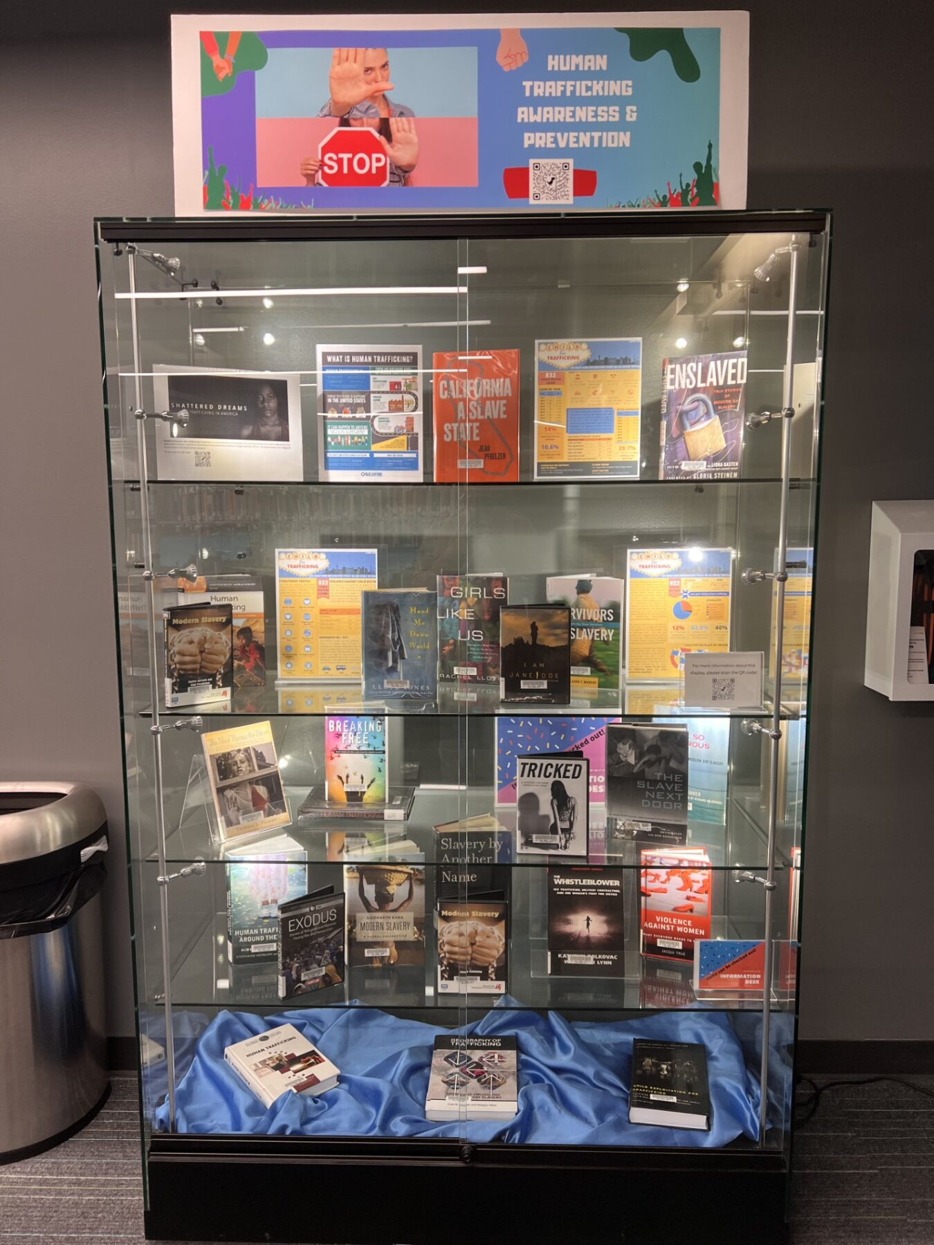 Human Trafficking Awareness and Preventen display case with books, photos and movies displayed
