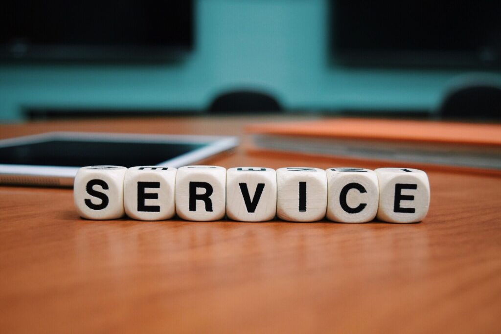 Letter blocks on a desk that spell Service
