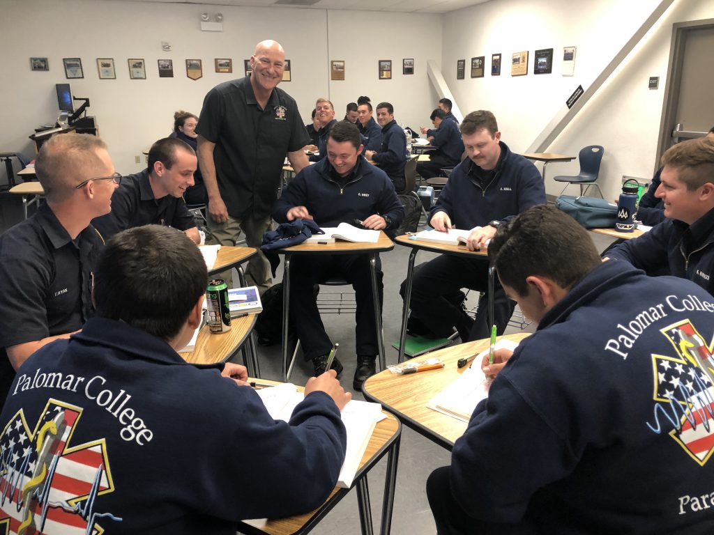 Students smiling and working together in a group in the classroom