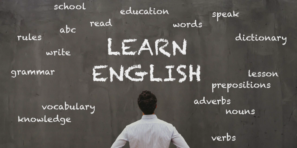 A person looking at the chalk board with many grammatical words on it.