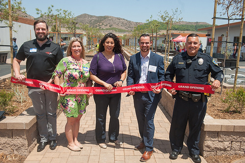 This image is of staff cutting the ribbon and includes Campus police, Assessment, Instruction, and Counseling