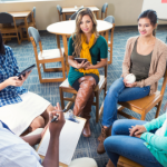 Students and professor in group therapy session.