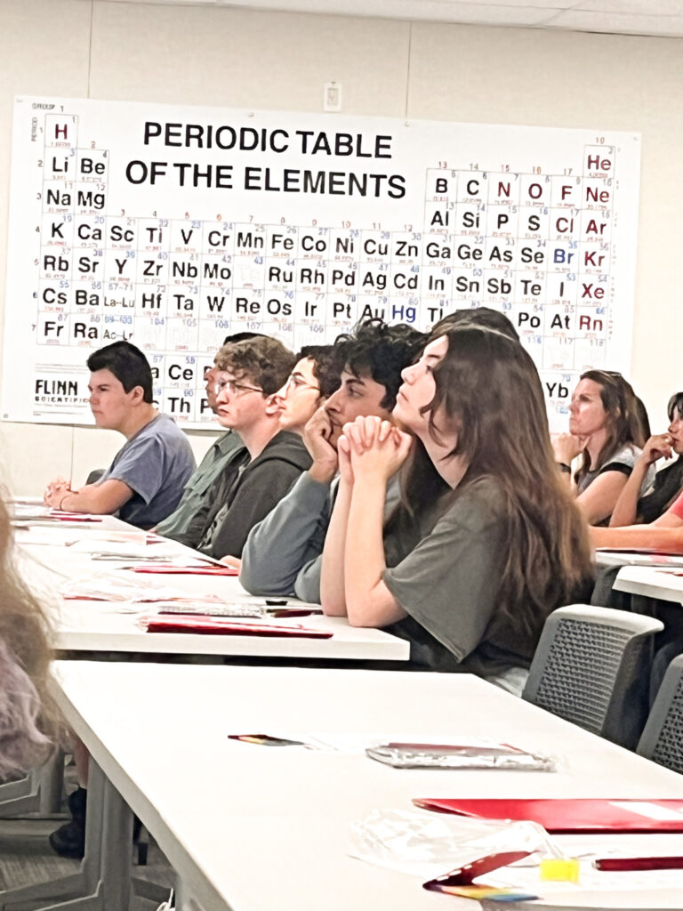 A group of Bonsall High School students listening intently to a lecture. 