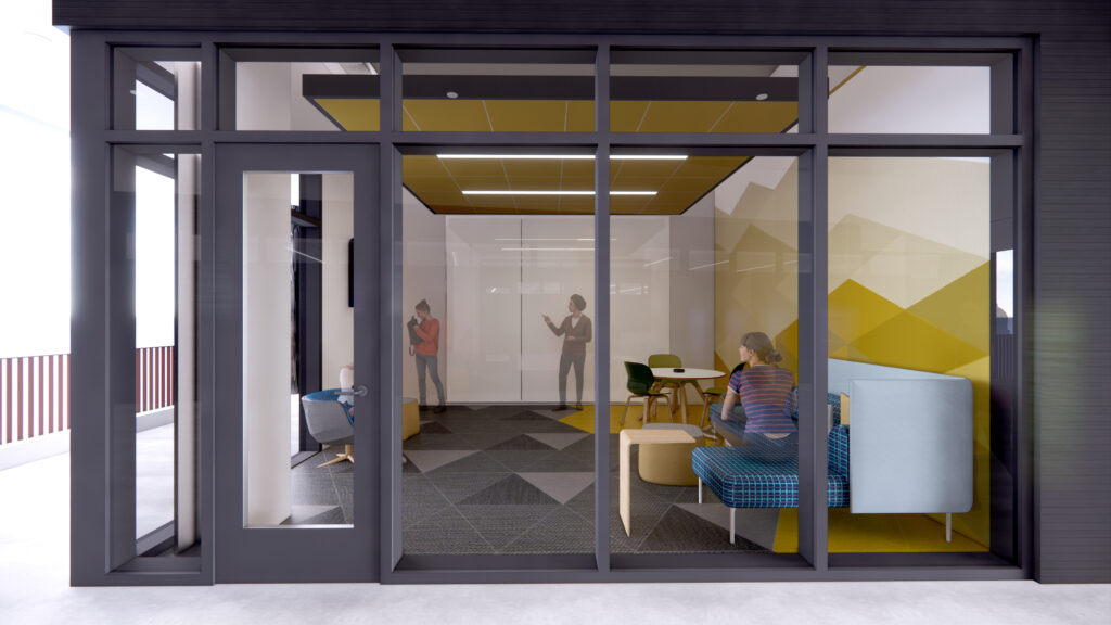  Interior view of a group study room with couches, tables, and a glass wall allowing visibility into adjacent spaces.