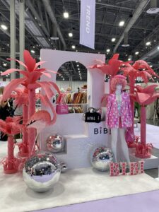 Pink palm trees and a mannequin dressed in a pink suit at the MAGIC Fashion Trade Show.