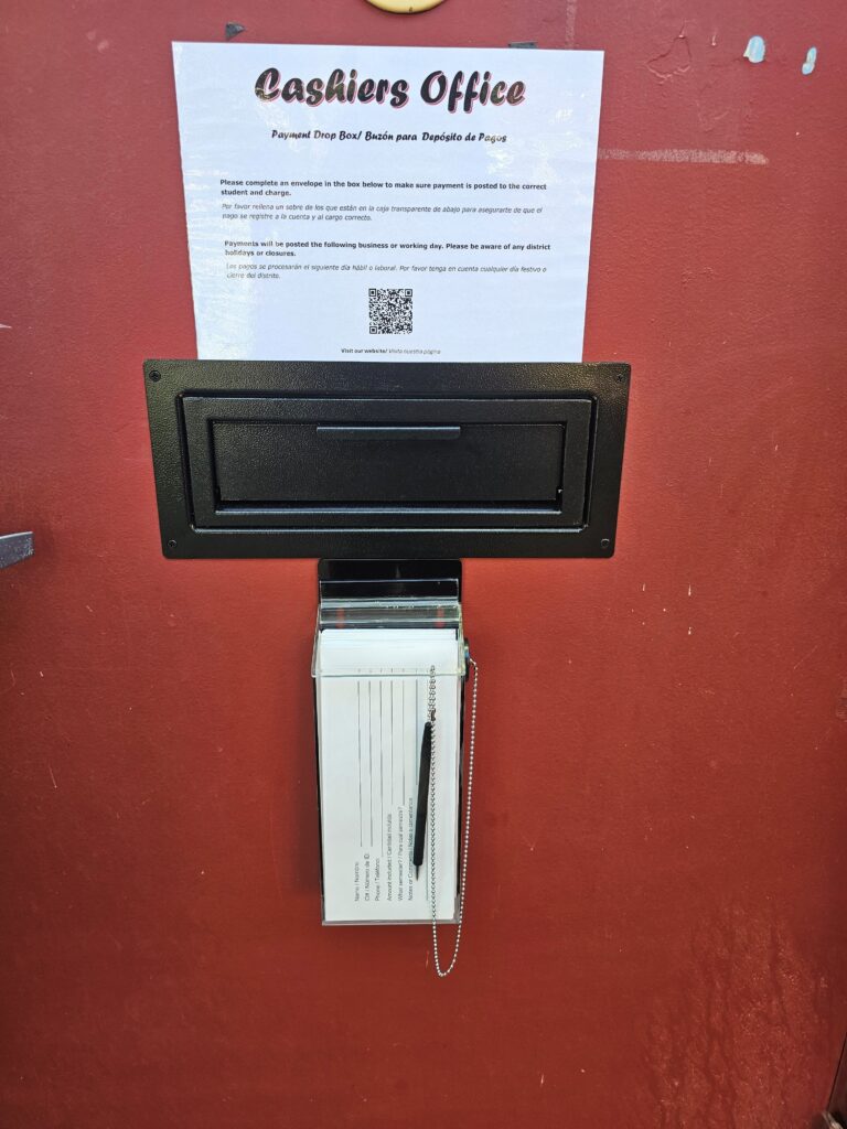 Drop Box located in the outside door with envelopes and pens. 
