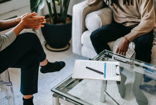 Unrecognizable man talking to female psychologist