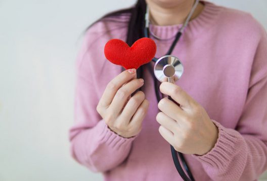 Woman with stethoscope and heart