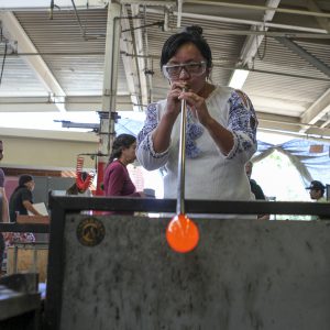 Palomar student Cecelia Cheung working on a piece of art in the glass blowing class at Palomar College. Photo by Aubree Wiedmaier/Impact Magazine