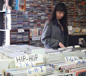 Valarie Ramos shops through Spindles record store. Andrew Meer/The Telescope