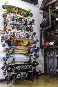 Wall display of Cali Strong’s skateboard collection.
