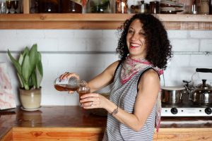Sonia Weksler pours some of the homemade kombucha she made at her store in North Park, Sleep Bedder/Sommeil.