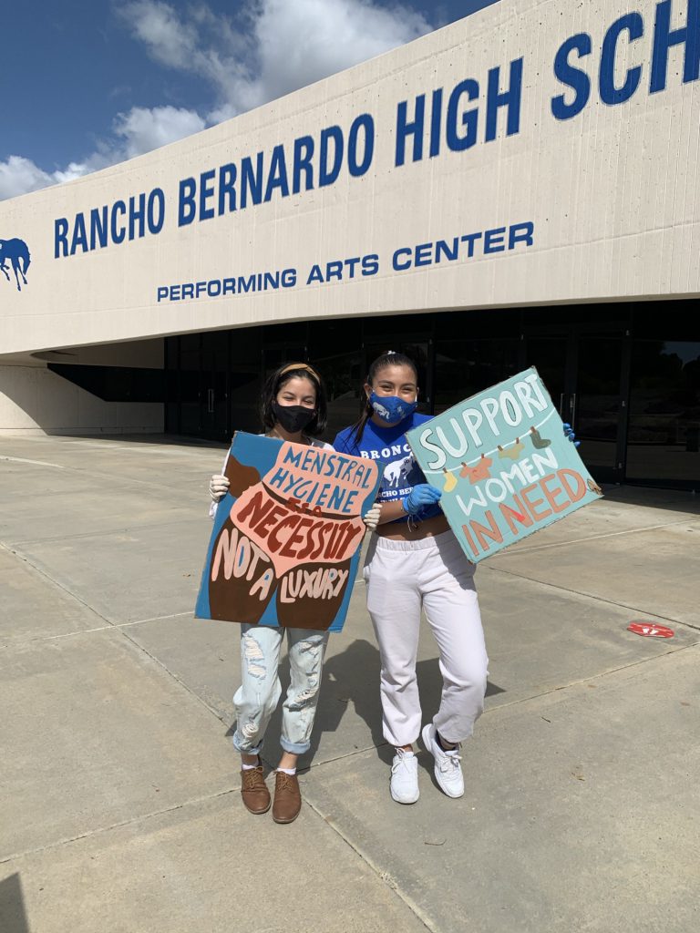 Gabby Le and a friend stands outside of Rancho Bernardo High School at a clothing and menstrual product community drive on April 2021. (Photo courtesy of Gabby Le.)