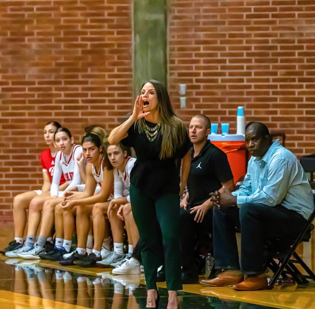 (l-r) Athena Sotelo, Rory Hetrick, Savana Smith, Kat Sciacca, and Assistant Coaches Chris Kroesch and Damian Cephas watches the game between Palomar and East L.A. while Head Coach Leigh Marshall calls out an offensive play. (Photo courtesy of Michael Pagan)
