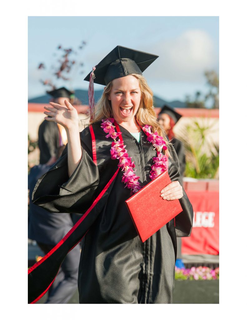 graduate holding diploma