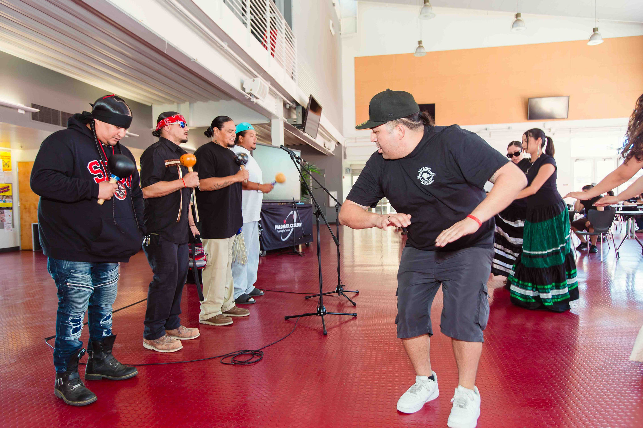 Bird Singer Joins Dance Bird singer dances alongside Bird dancers indoors.