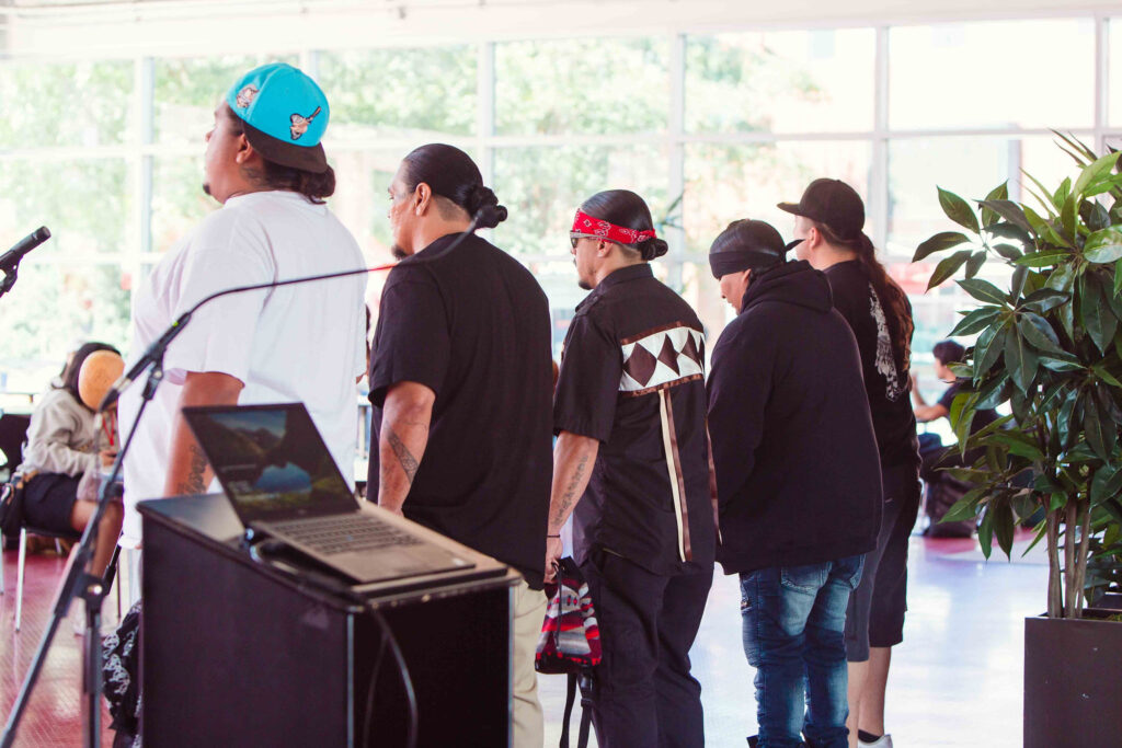 Five Bird Singers face attendees to welcome and bless the space.