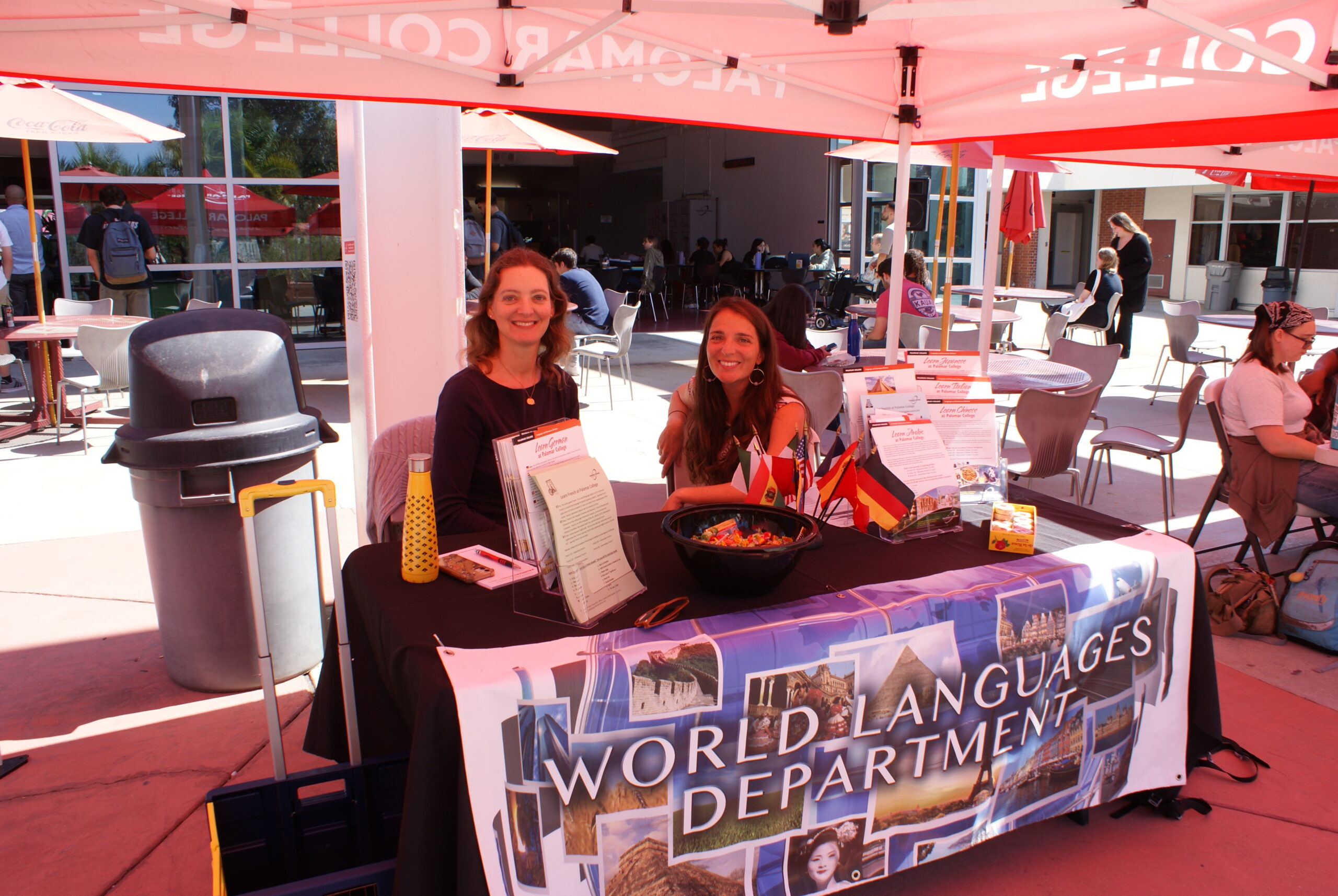 Language and Culture Resources A table with brochures, flags, and a decorative bowl under a World Languages Department banner.