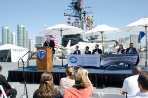 Palomar College Governing Board Trustee addressing the audience at a press conference held aboard the USS Midway Museum