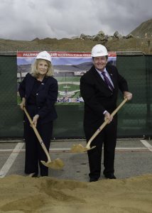 Governing board members holding shovels and wearing hard hats at the baseball field groundbreaking ceremony