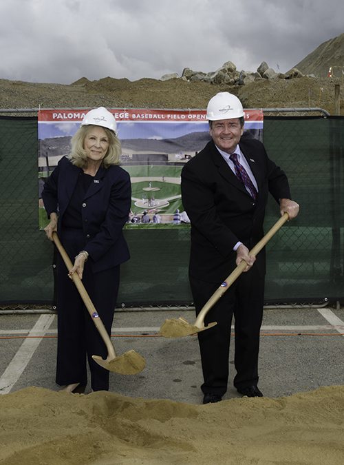 Governing board members holding shovels and wearing hard hats at the baseball field groundbreaking ceremony