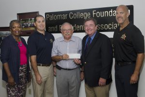 Palomar College Superintendent/President being presented with a check