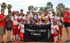 2015 women's softball team holding a state champs banner and trophy