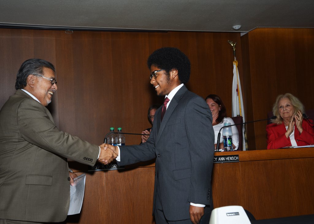 Palomar College Governing Board President congratulating the Associated Student Government (ASG) President after being sworn in