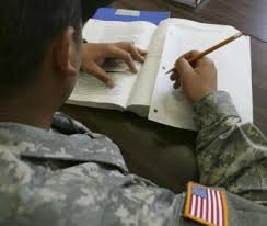 Veteran student in uniform studying with notes and a book