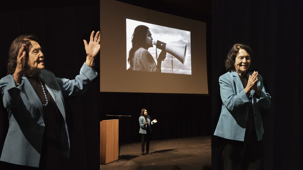 Labor leader and activist Dolores Huerta on stage addressing an audience at Palomar College